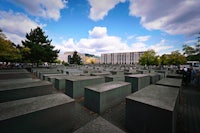 a group of people are standing in front of a group of concrete blocks