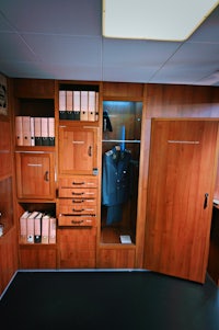 a room with a lot of cabinets and a desk