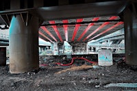 a red and white striped hose under a bridge