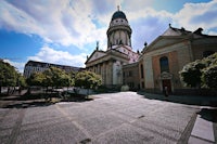a church with a clock tower in the background
