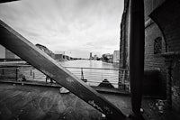 a black and white photo of a bridge over a river