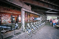 a row of bicycles parked in front of a building