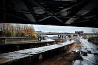 a view of a city from under a bridge