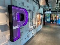 a neon sign with the word play on it