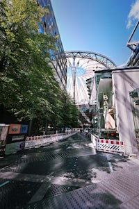 a city street with a large ferris wheel
