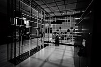 a black and white photo of a room with metal bars