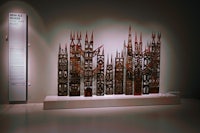 a group of wooden sculptures on display in a museum