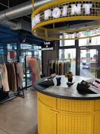 a yellow table with clothes on it in a store