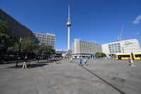 a city square with a tv tower in the background