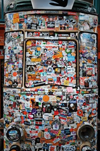 a vw bus covered in stickers