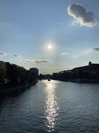the sun is shining over a body of water