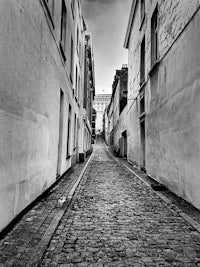 a black and white photo of a cobblestone street