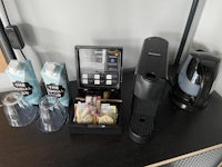 a desk with a coffee maker and other items on it