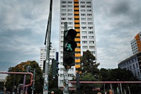 a traffic light on a pole in front of a tall building