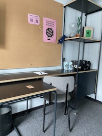 an office with a desk, chair and a bulletin board