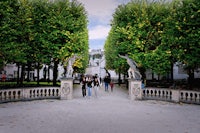 a group of people walking through a park