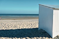 a beach hut sitting on the sand