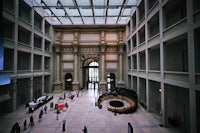 a large building with many people walking around