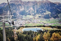 a gondola ride over a valley with mountains in the background