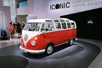 a red and white vw bus is on display in a museum