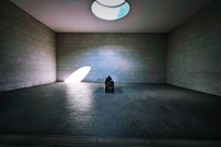a room with a light shining through a window
